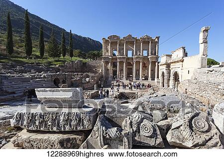 Stock Photograph - Tourists at the ruins of the Celsus Library, a monumental tomb for Gaius Julius Celsus Polemaeanus; Ephesus, Izmir, Turkey. Fotosearch