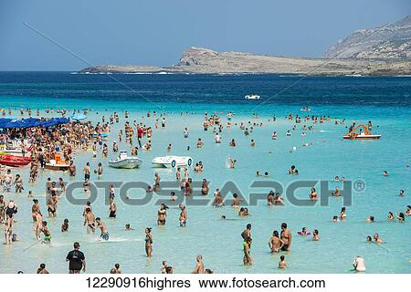 Tourists enjoying the turquoise waters of famous Pelosa Beach; Stintino, Sardinia, Italy View Large Photo Image Stock Photograph - Tourists enjoying the turquoise waters of famous Pelosa Beach; Stintino, Sardinia, Italy. Fotosearch