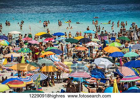 Tourists enjoying the turquoise waters of famous Pelosa Beach; Stintino, Sardinia, Italy View Large Photo Image Stock Photograph - Tourists enjoying the turquoise waters of famous Pelosa Beach; Stintino, Sardinia, Italy. Fotosearch