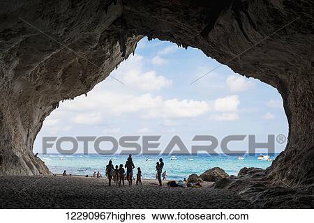 Tourists in a cave along the coast of the Mediterranean at Cala Luna; Golfo di Orosei, Sardinia, Italy View Large Photo Image Stock Photograph - Tourists in a cave along the coast of the Mediterranean at Cala Luna; Golfo di Orosei, Sardinia, Italy. Fotosearch