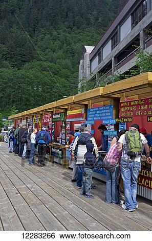 Tourists line up at eleven tour companies booths in a line at the cruise ship dock, Juneau, Southeast Alaska, Summer View Large Photo Image Stock Photograph - Tourists line up at eleven tour companies booths in a line at the cruise ship dock, Juneau, Southeast Alaska, Summer. Fotosearch