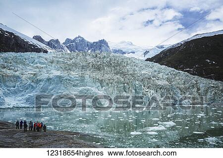 Stock Photograph - Tourists on excursion from tour boat to view Pia Glacier in Tierra del Fuego, Chilean Patagonia; Chile. Fotosearch
