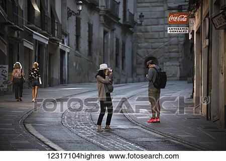 Stock Photograph - Tourists on the street way to the Alhambra; Granada, Andalucia, Spain. Fotosearch