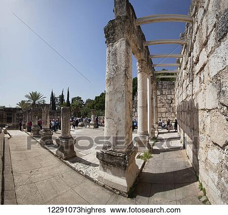 Stock Photograph - Tourists visit an ancient ruins site; Capernaum, Israel. Fotosearch