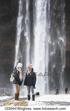 Tourists visit the Seljalandsfoss waterfall; Iceland View Large Photo Image Stock Photograph - Tourists visit the Seljalandsfoss waterfall; Iceland. Fotosearch