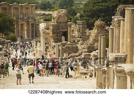 Stock Photograph - Tourists walking on Curetes Street to the Library of Celsus; Ephesus, Turkey. Fotosearch