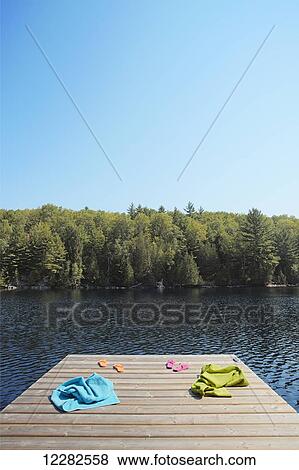 Towels and flip-flops on dock; Crystal Lake, Ontario, Canada View Large Photo Image Stock Photo - Towels and flip-flops on dock; Crystal Lake, Ontario, Canada. Fotosearch