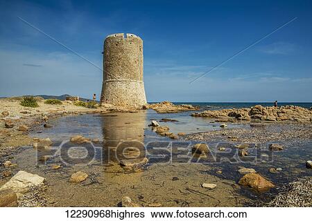 Stock Photograph - Tower reflected in a tranquil tide pool; San Teodoro, Sardinia, Italy. Fotosearch