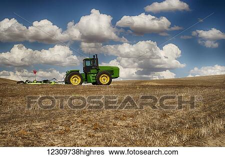 Stock Photograph - Tractor in a wheat field; Palouse, Washington, United States of America. Fotosearch