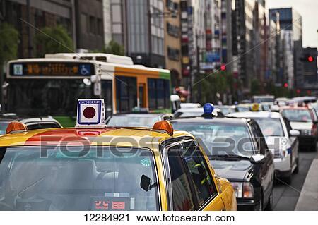 Stock Image - Traffic on a busy street; Tokyo, Japan. Fotosearch