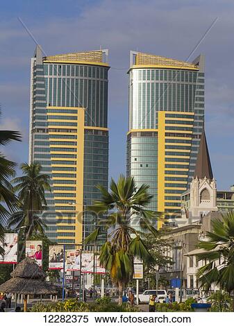Stock Photography - Twin buildings, St. Joseph's Cathedral and palm trees; Dar es Salaam, Tanzania. Fotosearch