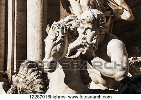 Stock Photograph - Two giant tritons conduct the winged chariot of Neptune-Ocean, Trevi Fountain; Rome, Italy. Fotosearch