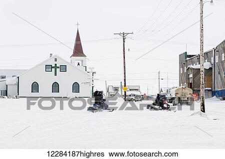 Two male native Alaskans ride snowmobiles in downtown Barrow, North Slope, Arctic Alaska, USA, Winter View Large Photo Image Stock Photograph - Two male native Alaskans ride snowmobiles in downtown Barrow, North Slope, Arctic Alaska, USA, Winter. Fotosearch
