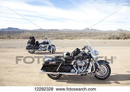 Stock Photo - Two motorcycles parked at the side of highway, Mohave Valley; Arizona, United States of America. Fotosearch