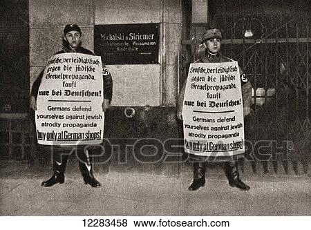 Two soldiers holding anti-Jewish propaganda in Berlin, Germany in 1933. From The Story of 25 Eventful Years in Pictures published 1935 View Large Photo Image Stock Photo - Two soldiers holding anti-Jewish propaganda in Berlin, Germany in 1933. From The Story of 25 Eventful Years in Pictures published 1935. Fotosearch