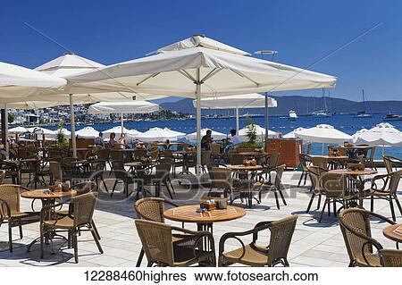 Stock Photograph - Umbrellas and chairs overlooking the sea; Bodrum, Turkey. Fotosearch