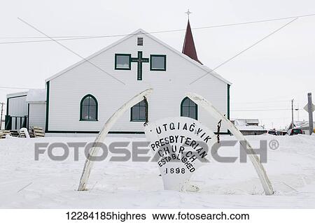 Stock Photograph - Utqiagvik Presbyterian Church with a whale bone sign in the foreground, Barrow, North Slope, Arctic Alaska, USA, Winter. Fotosearch