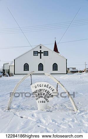 Stock Photograph - Utqiagvik Presbyterian Church with a whale bone sign in the foreground, Barrow, North Slope, Arctic Alaska, USA, Winter. Fotosearch