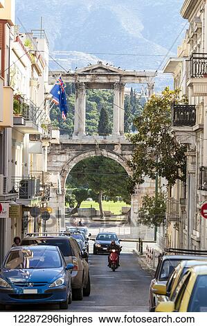 Stock Photograph - Vehicles and a motorcycle on narrow street; Athens, Greece. Fotosearch
