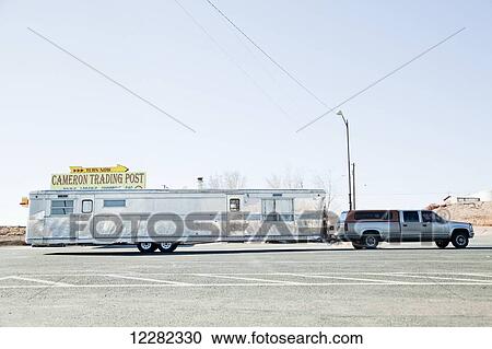 Stock Image - Very long trailer hitched to the back of a truck, Cameron Trading Post; Cameron, Arizona, United States of America. Fotosearch