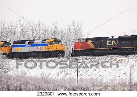 Stock Image - Via Rail train and Canadian National Railroad (CN) locomotives; Winnipeg, Manitoba, Canada. Fotosearch