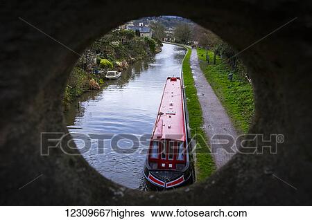 View of a canal boat on the River Avon through a hole in a stone wall; Bath, Somerset, England View Large Photo Image Stock Photograph - View of a canal boat on the River Avon through a hole in a stone wall; Bath, Somerset, England. Fotosearch
