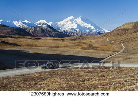 Stock Photograph - View of Denali and vehicle on Park Road at Stony Hill around Mile 60. Denali National Park & Preserve. Interior Alaska. Summer.. Fotosearch