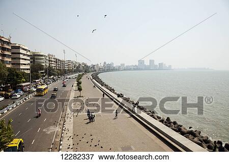 View of Marine Drive by the beach and boardwalk; Mumbai, India View Large Photo Image Stock Photo - View of Marine Drive by the beach and boardwalk; Mumbai, India. Fotosearch