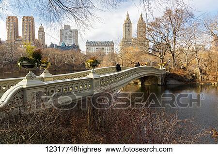 Stock Photograph - View of the curved Bow Bridge in Central Park; New York City, New York, United States of America. Fotosearch