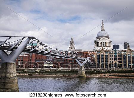Stock Photograph - View of the Millennium Bridge and St Paul's Cathedral from bankside of River Thames; London, England. Fotosearch