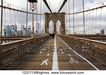 Stock Photograph - View of the New York City skyline from the Brooklyn Bridge; New York City, New York, United States of America. Fotosearch