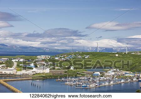 Stock Photograph - View Sand Point harbor and breakwaters of Popof Island on a sunny day, Southwestern Alaska, USA, summer. Fotosearch