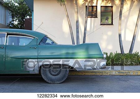 Vintage Cadillac parked outside a house; Varadero, Cuba View Large Photo Image Picture - Vintage Cadillac parked outside a house; Varadero, Cuba. Fotosearch