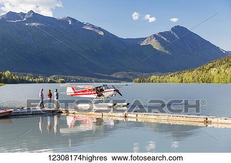Visitors wait for the pilot to dock while, Trail Lake Float Plane Base, Moose Pass, Kenai Peninsula, Southcentral Alaska, USA View Large Photo Image Stock Photograph - Visitors wait for the pilot to dock while, Trail Lake Float Plane Base, Moose Pass, Kenai Peninsula, Southcentral Alaska, USA. Fotosearch