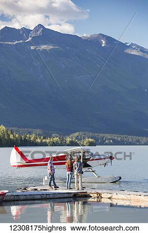 Visitors wait for the pilot to dock while, Trail Lake Float Plane Base, Moose Pass, Kenai Peninsula, Southcentral Alaska, USA View Large Photo Image Stock Photograph - Visitors wait for the pilot to dock while, Trail Lake Float Plane Base, Moose Pass, Kenai Peninsula, Southcentral Alaska, USA. Fotosearch