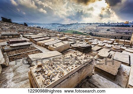 Stock Photograph - Western slope of the Mount of Olives covered by thousands of Jewish graves facing toward the Temple Mount and the Eastern Gate of the old city of Jerusalem; Jerusalem, Israel. Fotosearch