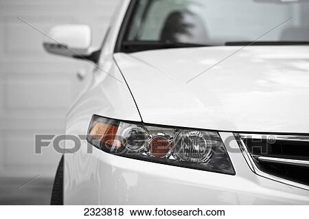Stock Photo - White sport sedan car, parked in driveway, close up, front view; Winnipeg, Manitoba, Canada. Fotosearch