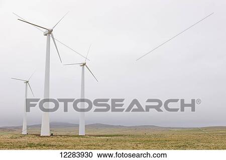 Stock Image - Wind turbines on green tundra, St. Paul Island, Southwestern Alaska, USA, Summer. Fotosearch