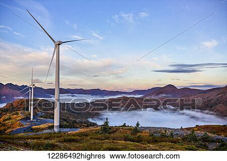 Stock Photograph - Wind turbines with low fog patches on Pillar Mountain, Kodiak, Alaska, fall. Fotosearch