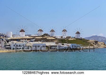 Stock Photograph - Windmills and tourist destination; Chora, Mykonos, Greece. Fotosearch