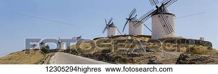 Stock Photograph - Windmills lining a road; Consuegra, Castile-La Mancha, Spain. Fotosearch