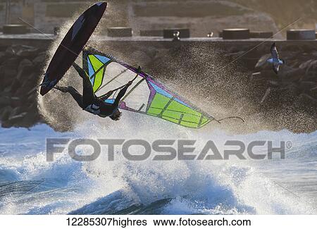 Stock Photograph - Windsurfer flipping upside down over the water; Tarifa, Cadiz, Andalusia, Spain. Fotosearch