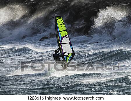 Stock Photograph - Windsurfer in the waves; Tarifa, Cadiz, Andalusia, Spain. Fotosearch