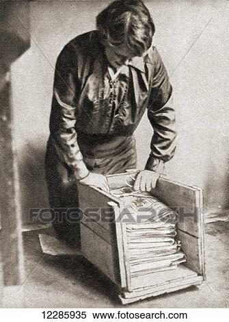 Stock Photography - With paper at 9d. per pound, housewives stored old newspapers for re-sale to fishmongers etc during World War One. From The Pageant of the Century, published 1934. Fotosearch