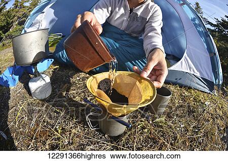 Woman backpacker prepares coffee at camp near Upper Fuller Lake in the Kenai National Wildlife Refuge on the Kenai Peninsula in South-central Alaska View Large Photo Image Stock Photograph - Woman backpacker prepares coffee at camp near Upper Fuller Lake in the Kenai National Wildlife Refuge on the Kenai Peninsula in South-central Alaska. Fotosearch