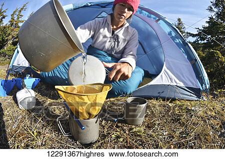 Woman backpacker prepares coffee at camp near Upper Fuller Lake in the Kenai National Wildlife Refuge on the Kenai Peninsula in South-central Alaska View Large Photo Image Stock Photograph - Woman backpacker prepares coffee at camp near Upper Fuller Lake in the Kenai National Wildlife Refuge on the Kenai Peninsula in South-central Alaska. Fotosearch