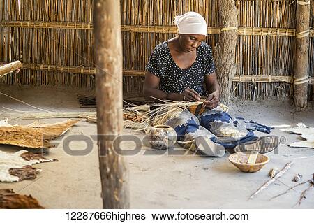 Stock Photograph - Woman in Sexaxa village making handmade bowls; Maun, Botswana. Fotosearch