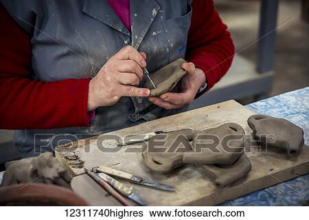 Stock Photograph - Woman molding some pottery at Vieira Pottery; Lagoa, Sao Miguel, Azores, Portugal. Fotosearch
