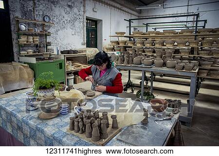 Stock Photograph - Woman molding some pottery at Vieira Pottery; Lagoa, Sao Miguel, Azores, Portugal. Fotosearch