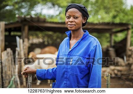 Stock Photograph - Woman on farm with damara sheep; Ghanzi, Botswana. Fotosearch